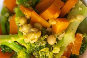 Colorful steamed vegetables mix in a bowl, healthy eating concept.